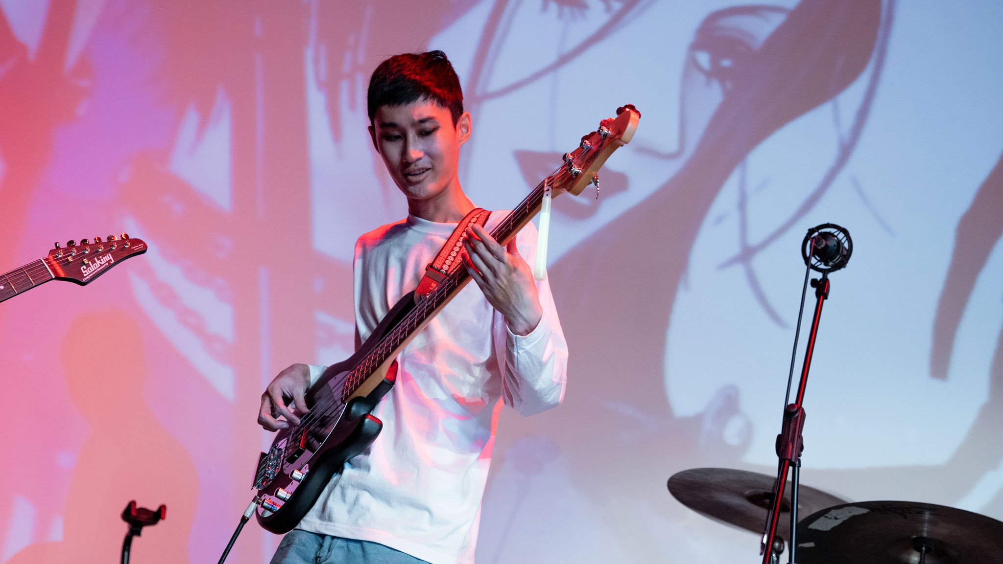 A boy happily play bass guitar after he learns to play from Major Music Bass Lesson in Puchong